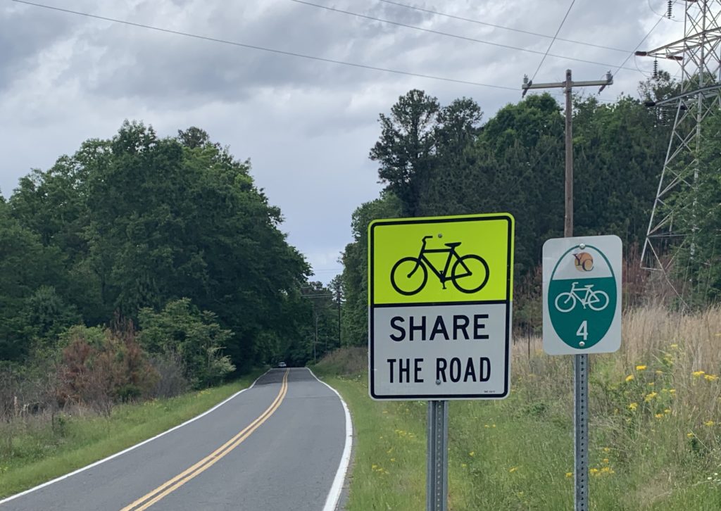 signage for Share the Road and numbering the bike routes in York County (shown: Dam Road, Tega Cay)